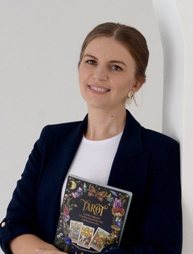 Наталья Лозовая, основательница NL School, с книгой по Таро